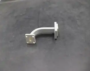 How do bend radius, waveguide dimensions, and frequency affect signal loss in E bend waveguides?